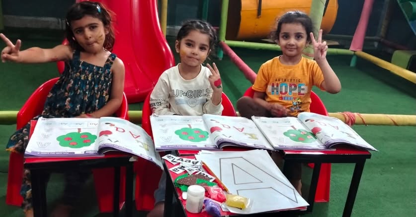 Young Wisdom School students working on activity worksheets